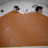 Workers spread peanut butter on a floor at the Museum Boijmans Van Beuningen, Rotterdam, Netherlands, July 3, 2026.