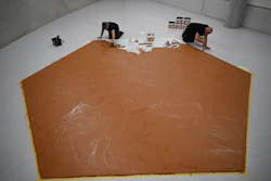 Workers spread peanut butter on a floor at the Museum Boijmans Van Beuningen, Rotterdam, Netherlands, July 3, 2026.