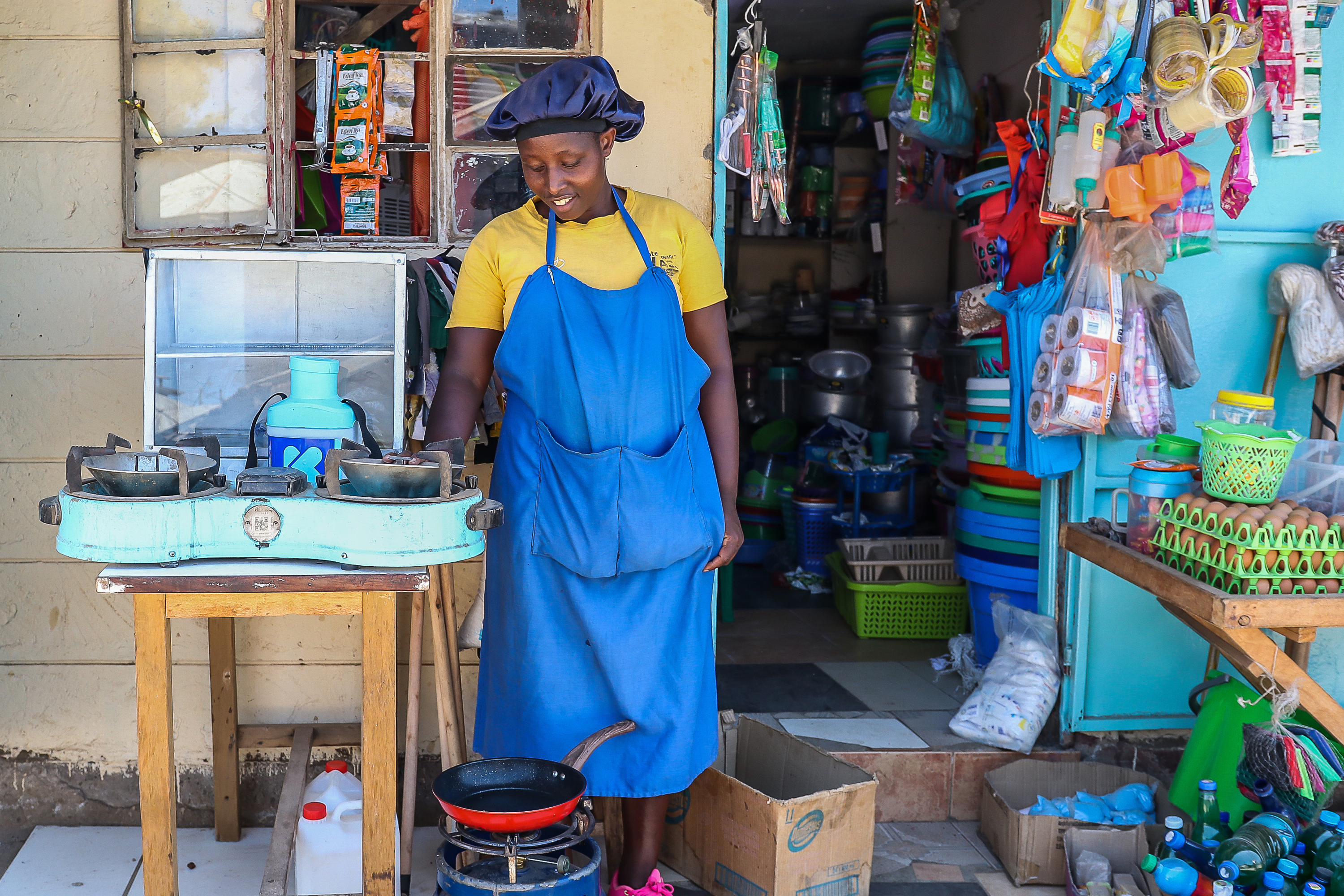 Grace Kathambi uses a bioethanol fuel stove to fry and sell French fries at her shop in Kibera, an informal settlement on the outskirts of Nairobi, Kenya, Feb. 4, 2026.