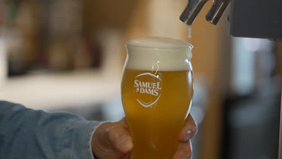 Boston Beer Co. founder and CEO Jim Koch pours a beer at the company's headquarters in Boston, July 7, 2026.
