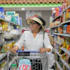 Elizabeth Martínez pushes a shopping cart through a grocery store aisle, July 2, 2026, Cleveland, Texas.