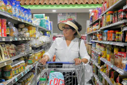 Elizabeth Martínez pushes a shopping cart through a grocery store aisle, July 2, 2026, Cleveland, Texas.