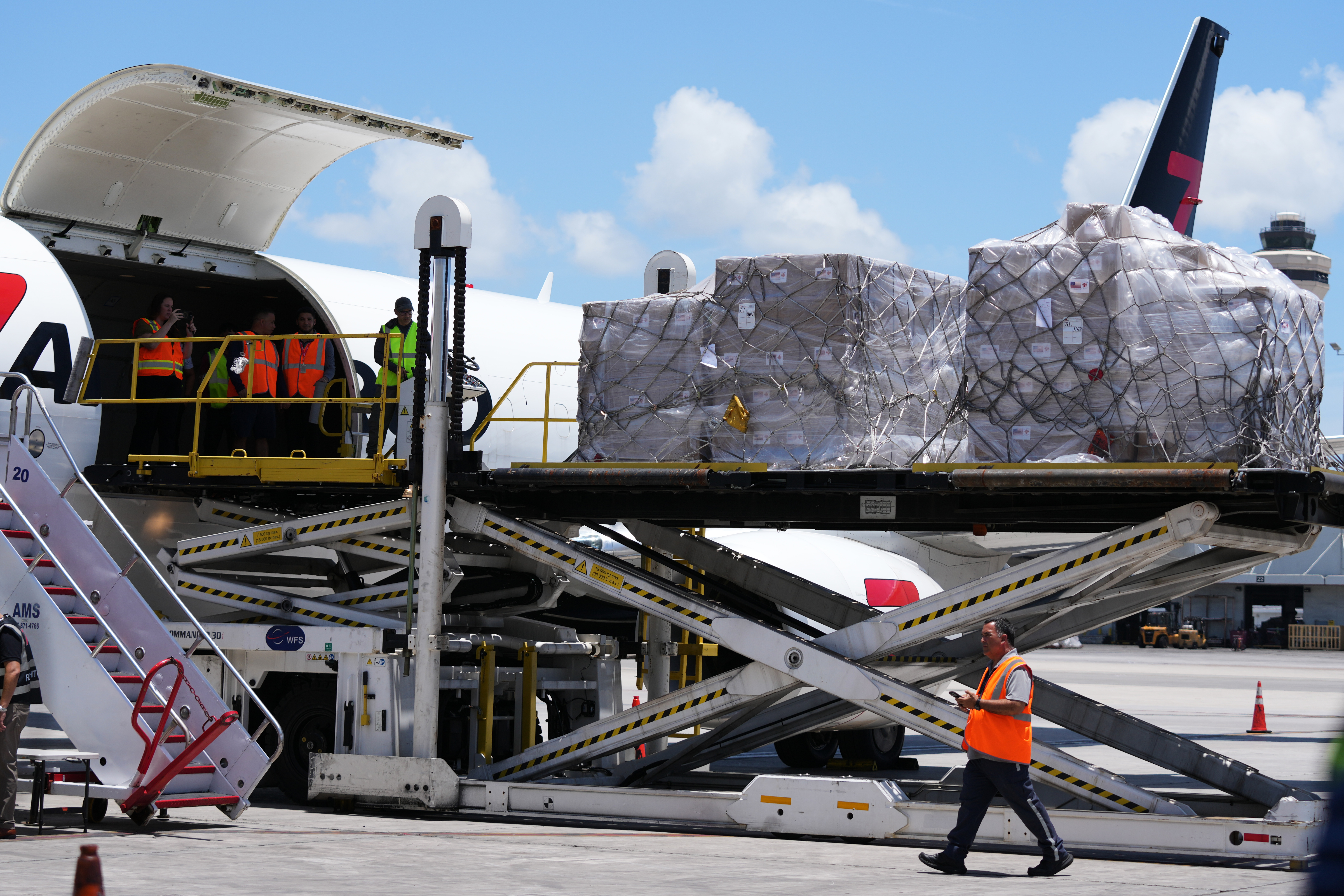 People load pallets containing food and hygiene kits for a humanitarian assistance flight to Cuba, July 21, 2026, Miami.