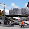 People load pallets containing food and hygiene kits for a humanitarian assistance flight to Cuba, July 21, 2026, Miami.