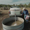 Mark Ragsdale refills a stock tank, July 17, 2026, Redvale, Colo.