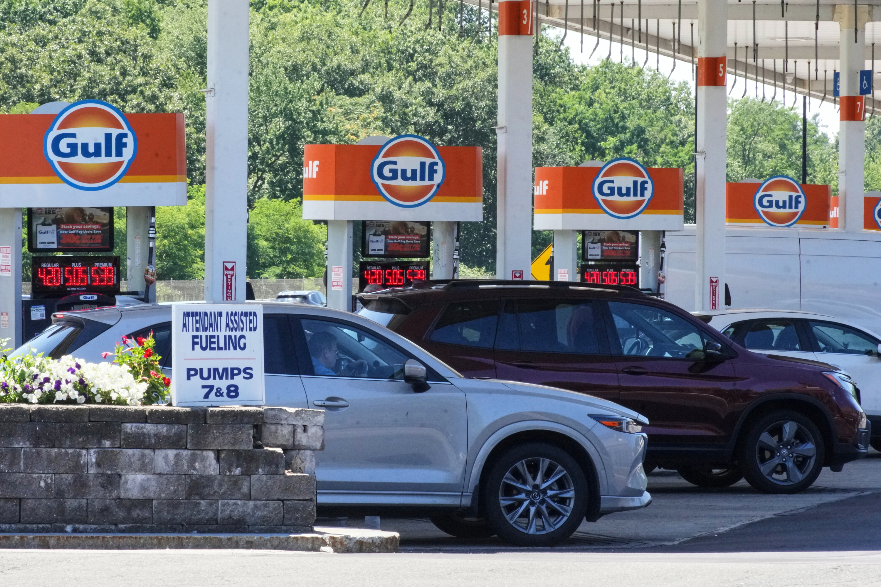 Cars line up at the pumps of a Gulf Oil station on the Massachusetts Turnpike near Boston, July 19, 2026.