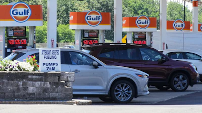 Cars line up at the pumps of a Gulf Oil station on the Massachusetts Turnpike near Boston, July 19, 2026.