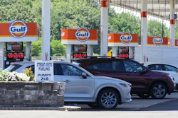Cars line up at the pumps of a Gulf Oil station on the Massachusetts Turnpike near Boston, July 19, 2026.