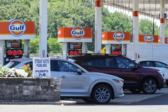 Cars line up at the pumps of a Gulf Oil station on the Massachusetts Turnpike near Boston, July 19, 2026.