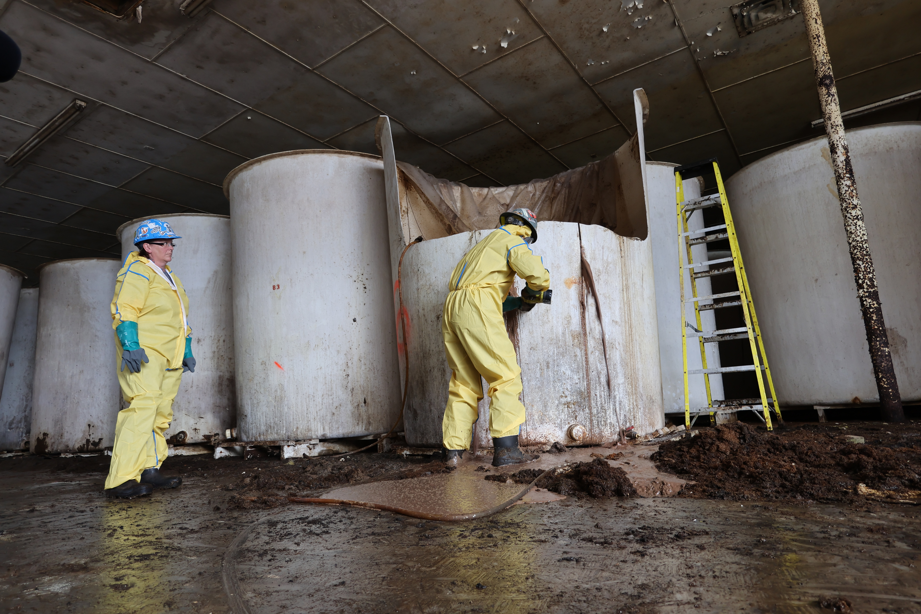 Sludge pours out of a vat of fermenting fish sauce in an abandoned factory, St. Mary's, Newfoundland and Labrador, July 28, 2026.