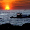 Lobster fishermen work at sunrise off Kennebunkport, Maine, Sept. 8, 2022.