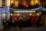 People stand outside the Coach & Horses pub, London, March 17, 2020.