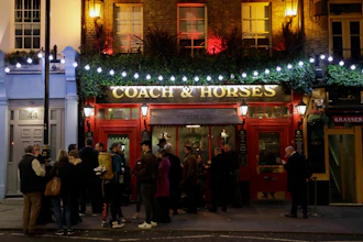 People stand outside the Coach & Horses pub, London, March 17, 2020.