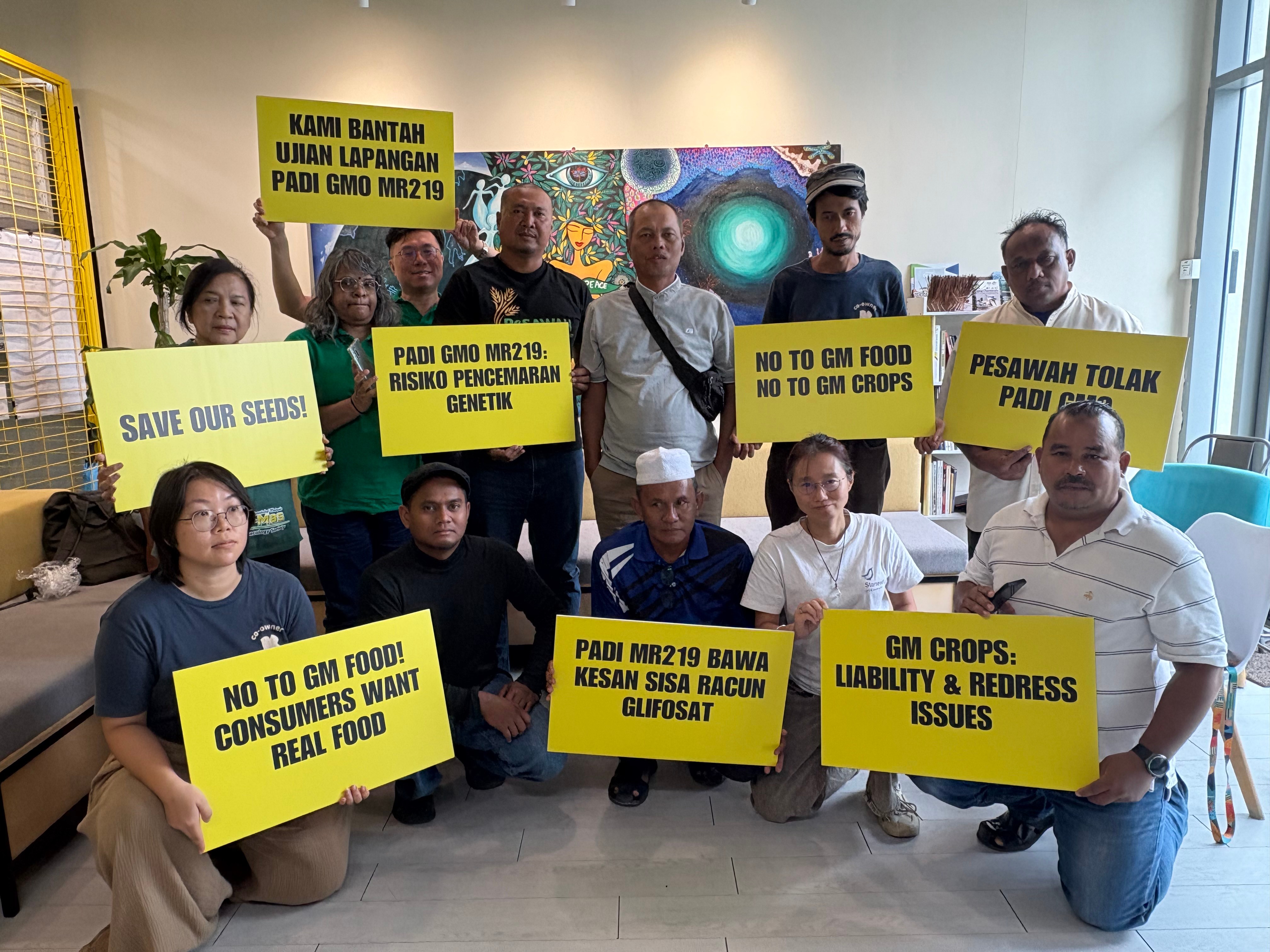 A coalition of farmers, consumer and environmental groups hold placards after a press conference at the Greenpeace office in Kuala Lumpur, Aug. 11, 2026.