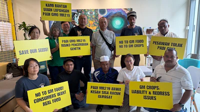 A coalition of farmers, consumer and environmental groups hold placards after a press conference at the Greenpeace office in Kuala Lumpur, Aug. 11, 2026.