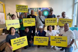 A coalition of farmers, consumer and environmental groups hold placards after a press conference at the Greenpeace office in Kuala Lumpur, Aug. 11, 2026.