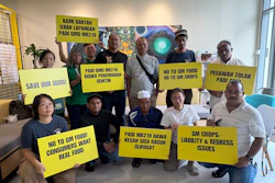 A coalition of farmers, consumer and environmental groups hold placards after a press conference at the Greenpeace office in Kuala Lumpur, Aug. 11, 2026.