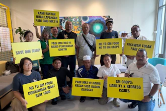 A coalition of farmers, consumer and environmental groups hold placards after a press conference at the Greenpeace office in Kuala Lumpur, Aug. 11, 2026.