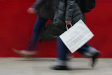 A person carries a shopping bag in Philadelphia, Dec. 10, 2025.