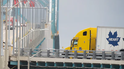 Transport trucks cross the Ambassador Bridge into the U.S. in Windsor, Ontario, Aug. 22, 2026.