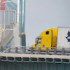 Transport trucks cross the Ambassador Bridge into the U.S. in Windsor, Ontario, Aug. 22, 2026.