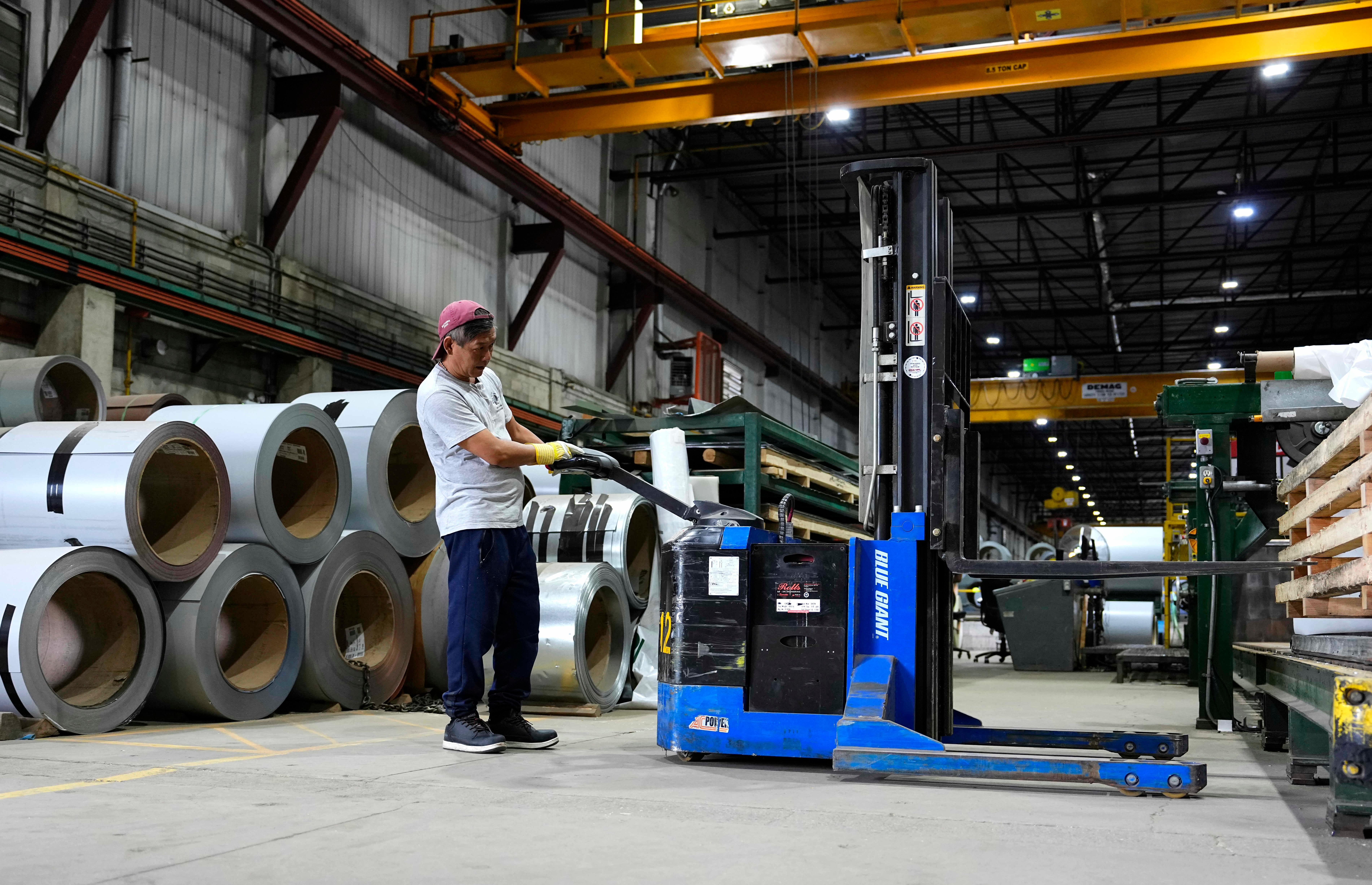 A worker operates a forklift in front of steel coils at Ideal Roofing in Ottawa, Aug. 25, 2026.