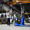 A worker operates a forklift in front of steel coils at Ideal Roofing in Ottawa, Aug. 25, 2026.