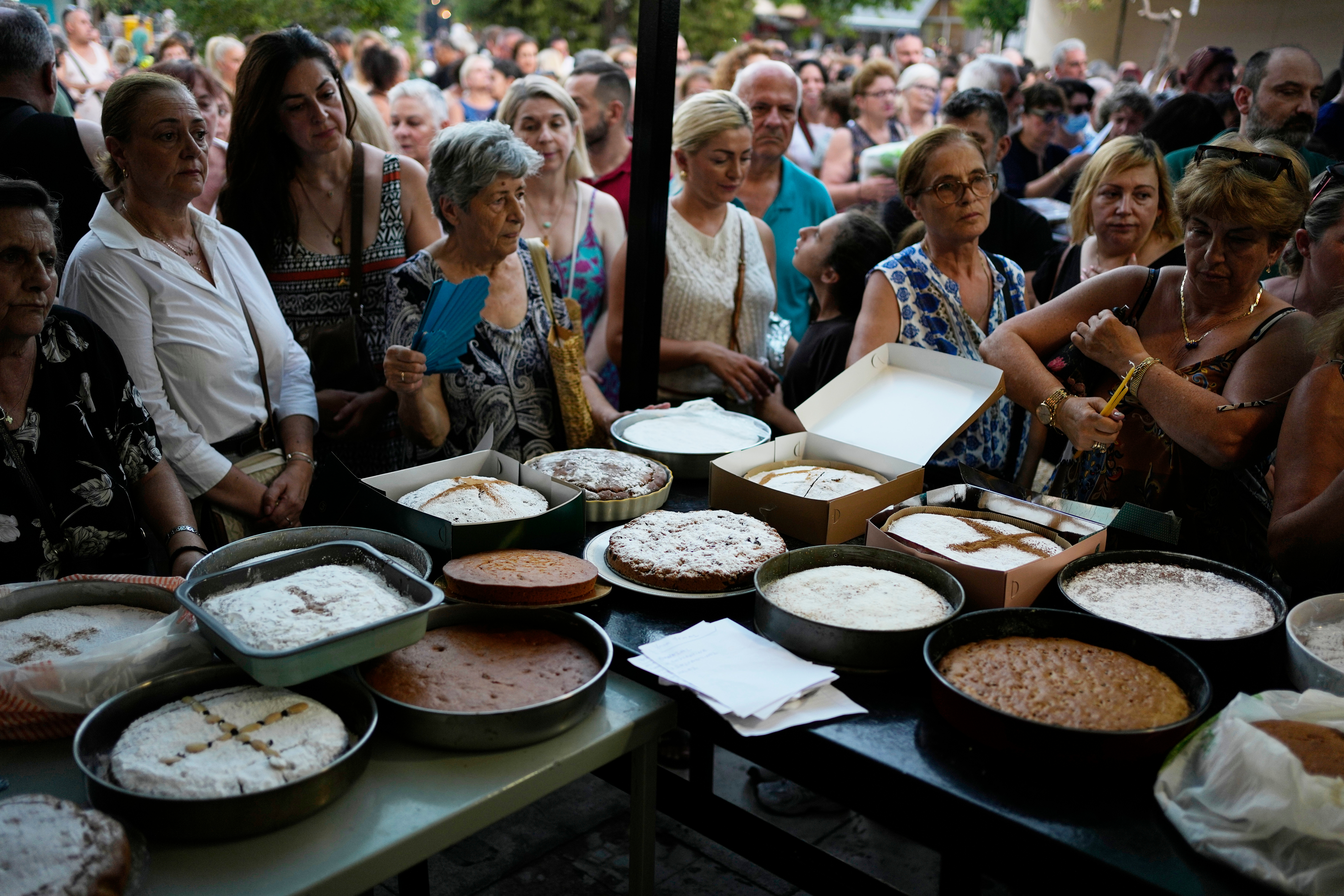 Pilgrims wait in line to have their Fanouropites blessed at the Church of St. Fanourios, Athens, Aug. 26, 2026.