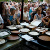 Pilgrims wait in line to have their Fanouropites blessed at the Church of St. Fanourios, Athens, Aug. 26, 2026.