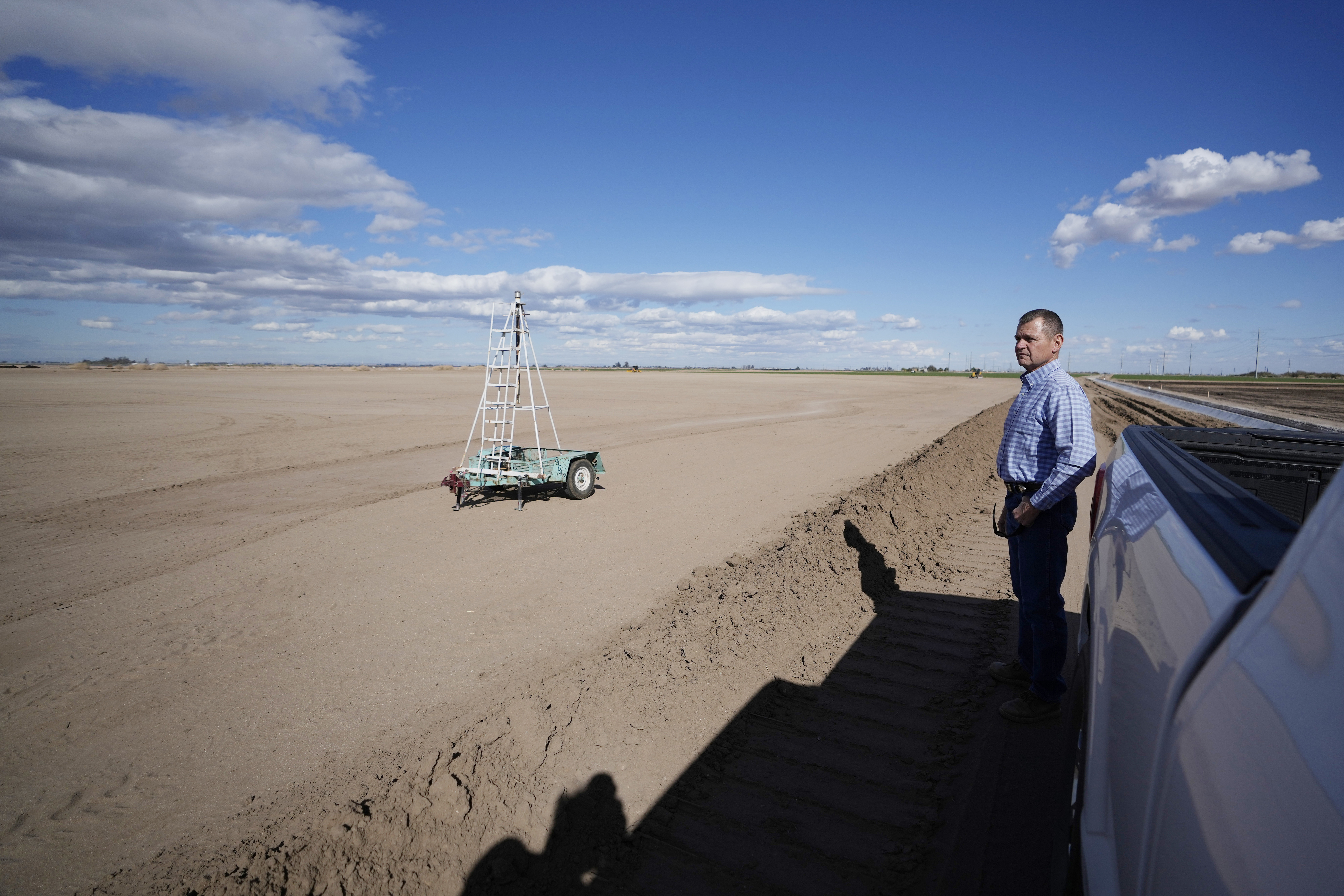 Tom Brundy looks over his field that is being prepared for planting near Calexico, Calif., Feb. 28, 2023.