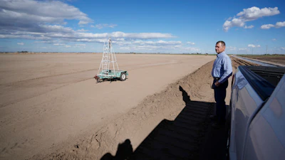 Tom Brundy looks over his field that is being prepared for planting near Calexico, Calif., Feb. 28, 2023.