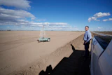 Tom Brundy looks over his field that is being prepared for planting near Calexico, Calif., Feb. 28, 2023.