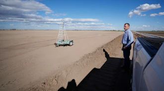 Tom Brundy looks over his field that is being prepared for planting near Calexico, Calif., Feb. 28, 2023.