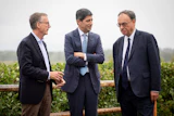 Fed Chair Kevin Warsh, center, talks to Bank of England Governor Andrew Bailey, right, and Bank of Canada Governor Tiff Macklem at the annual Jackson Hole Economic Policy Symposium, Aug. 28, 2026, Moran, Wyo.