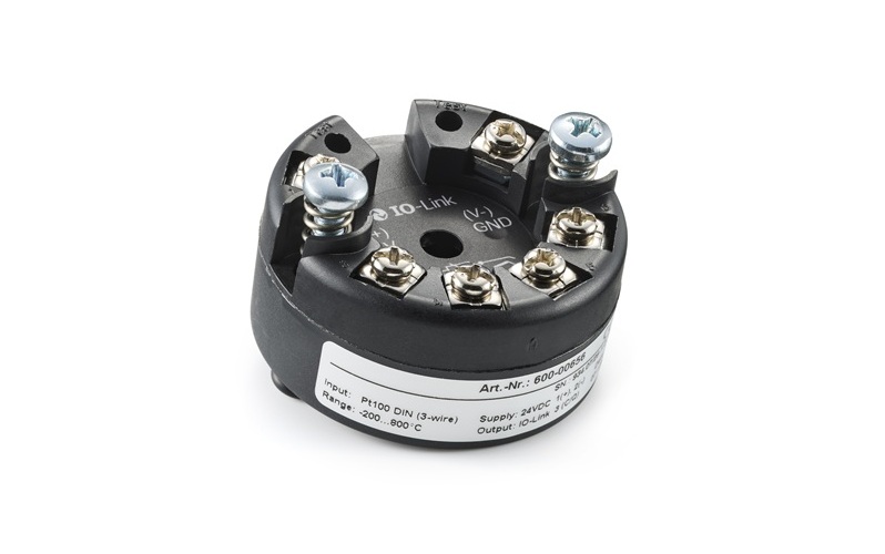 Industrial RTD temperature transmitter with black housing, metal terminals, and technical specifications label