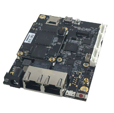 Black circuit board with processor, memory chips, and network connectors viewed from above
