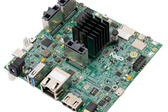 Green circuit board motherboard with black heatsink, multiple connectors, and integrated electronic components