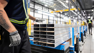 Workers prepare extruded aluminum product for packaging at Magna Aluminum Profile's fully electric powered extrusion facility in Salaberry-de-Valleyfield, Quebec, Canada, on Sept. 3, 2025.