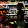 Shoppers browse the produce section at a Target store, Aug. 13, 2026, Woodbury, Minn.