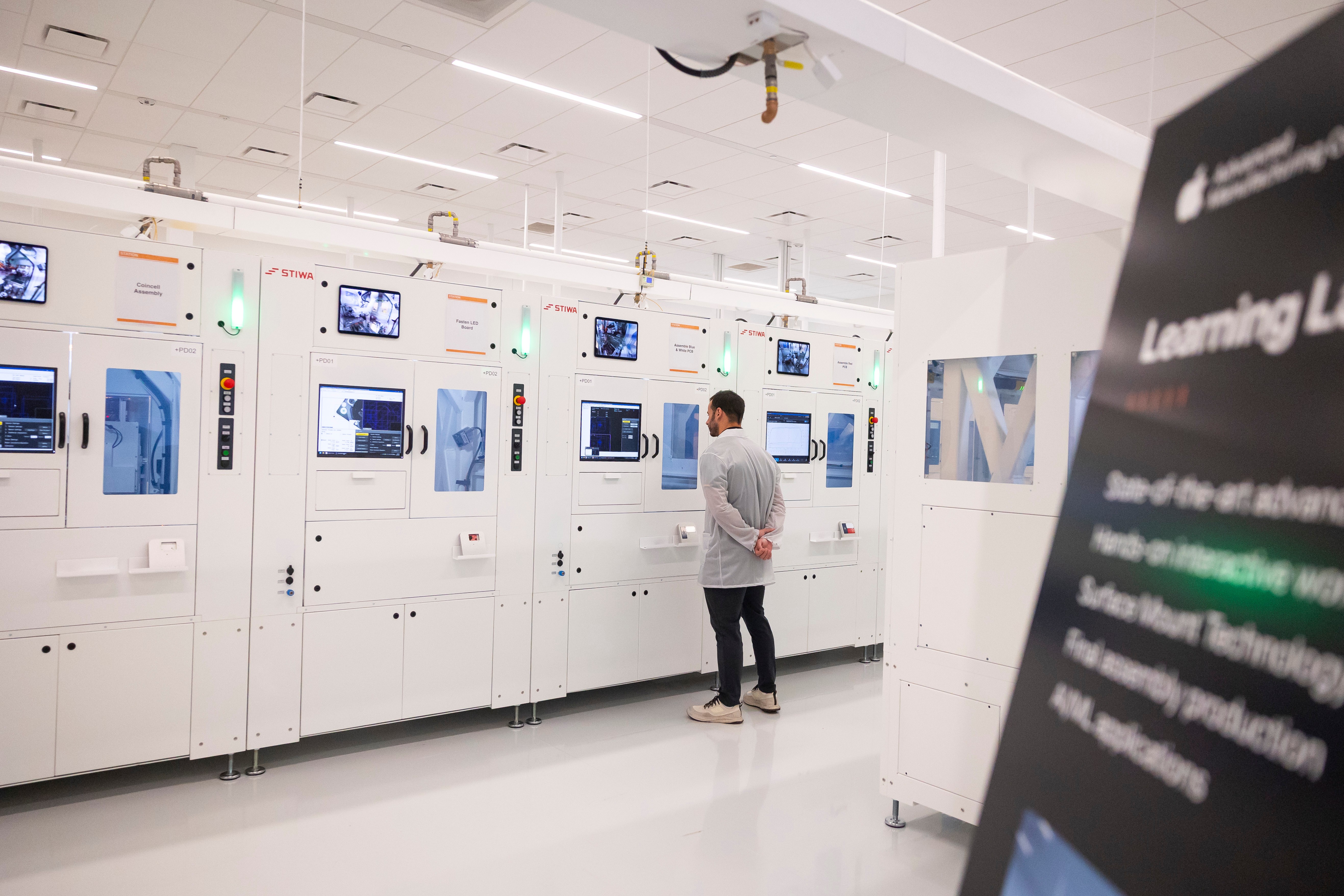 An Apple employee watches a machine in a learning lab at Apple's Advanced Manufacturing Center, Houston, Aug. 13, 2026.