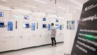 An Apple employee watches a machine in a learning lab at Apple's Advanced Manufacturing Center, Houston, Aug. 13, 2026.