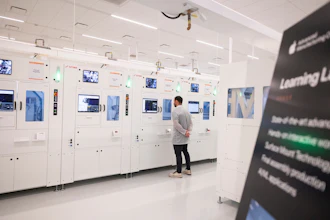 An Apple employee watches a machine in a learning lab at Apple's Advanced Manufacturing Center, Houston, Aug. 13, 2026.