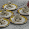 Chef Zhou Tong prepares red bean rolls at Fangshan Restaurant inside Beihai Park, Beijing, July 23, 2026.