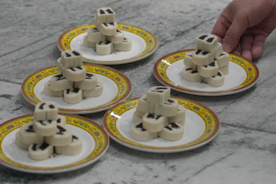 Chef Zhou Tong prepares red bean rolls at Fangshan Restaurant inside Beihai Park, Beijing, July 23, 2026.