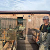 Fisherman Federico Zago poses next to a trap containing blue crabs at his fishing cabin over the Scardovari Lagoon in Italy's Po River Delta, Aug. 21, 2026.