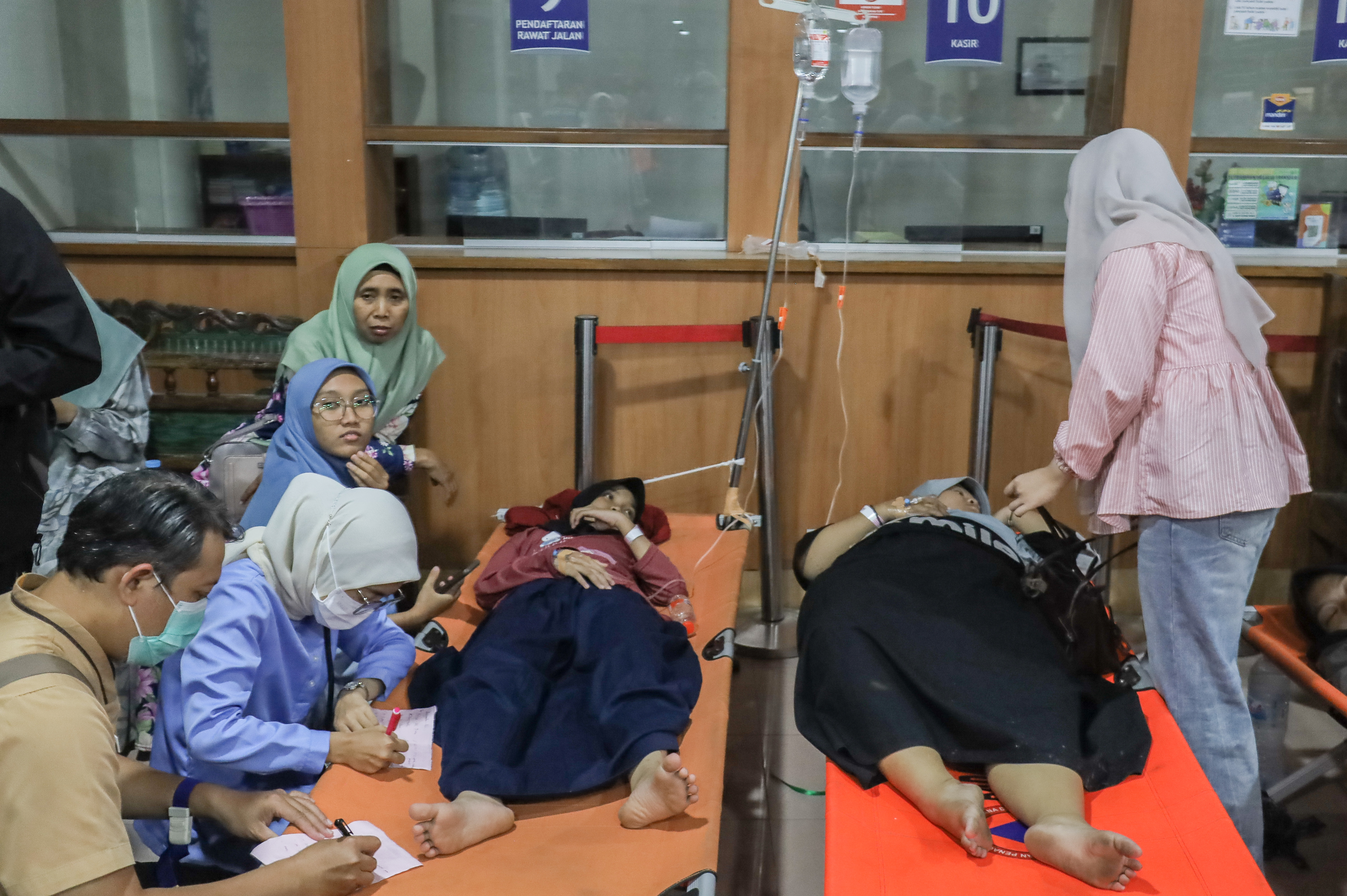 Students who fell ill, allegedly due to food poisoning after consuming free meals at their school, receive medical treatment at a hospital in Sidoarjo, East Java, Indonesia, Sept. 2, 2026.