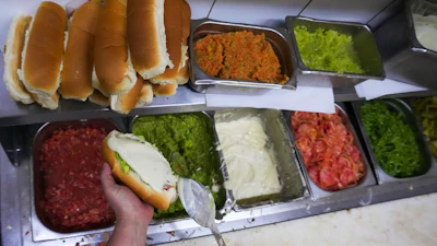 A cook prepares 'completos' at a restaurant in Santiago, Chile, Sept. 14, 2026.