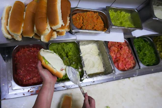 A cook prepares 'completos' at a restaurant in Santiago, Chile, Sept. 14, 2026.
