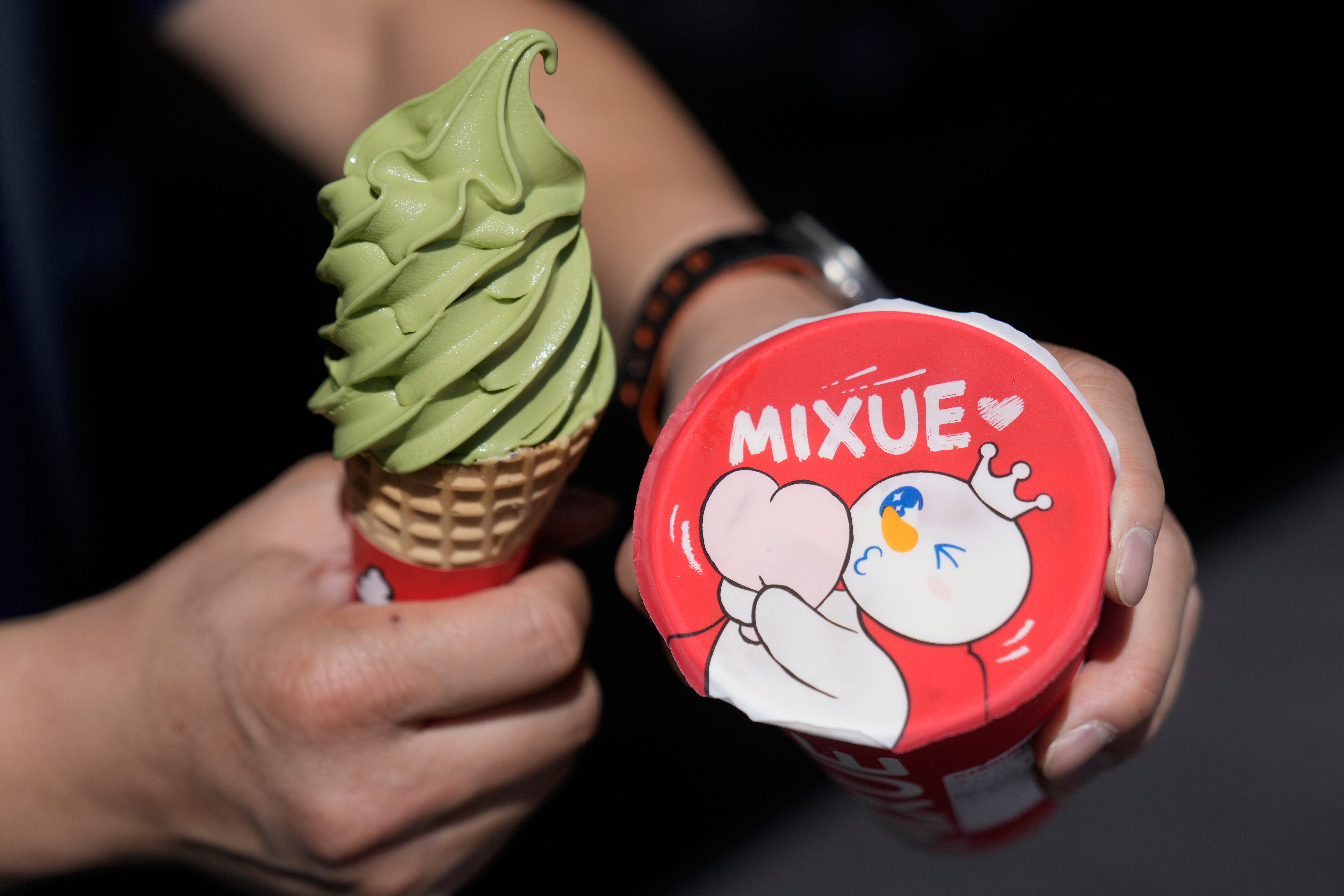 A customer holds an ice cream cone outside of a Mixue store, Sept. 16, 2026, Sunnyvale, Calif.