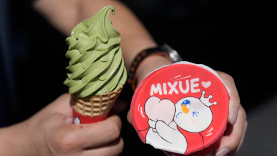 A customer holds an ice cream cone outside of a Mixue store, Sept. 16, 2026, Sunnyvale, Calif.